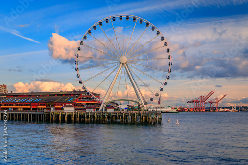 Downtown waterfront skyline with skyscrapers and a view over the Great Wheel, the Puget Sound at sunset in Seattle, Washington, USA