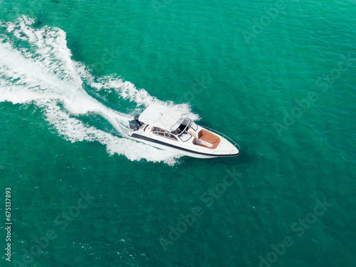 Aerial view of Speed boat at high speed in the aqua sea, Drone view. © Touchr