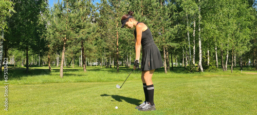 Lady golf is swinging on the golf course. © Nadzeya