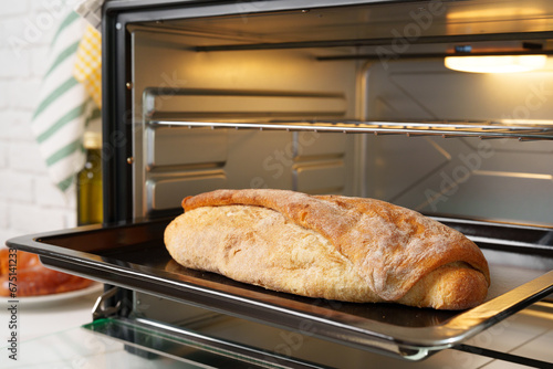 Freshly baked bread in mini oven in the kitchen