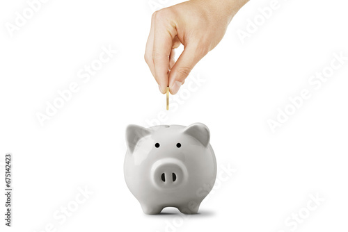 Male Hand Putting A Coin Into Piggy Bank