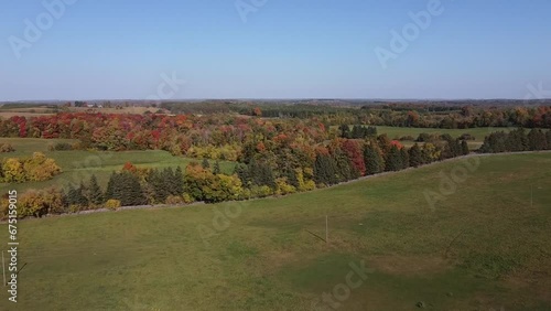 Aerial Shot Of Agricultural Farmland Surrounded By Fall Colours photo