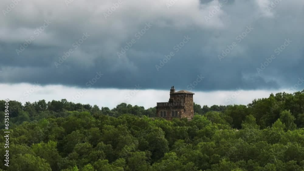 Dromborg Castle In The Ozark Mountains Against Cloudy Sky In Fayetteville, Arkansas. drone ascend, parallax effect Dromborg Castle In The Ozark Mountains Against Cloudy Sky In Fayetteville, Arkansas. drone ascend, parallax effect