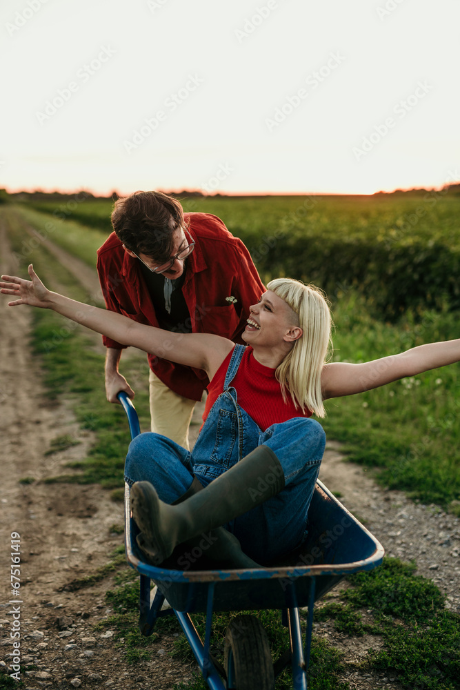 Two people embracing as the sun sets over the rural landscape Two people embracing as the sun sets over the rural landscape