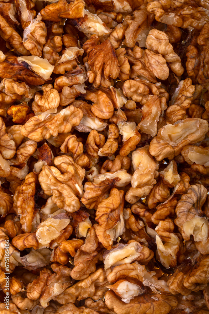 Walnuts on a black brown background.