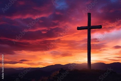 Silhouette of a cross on against a colorful sunset sky