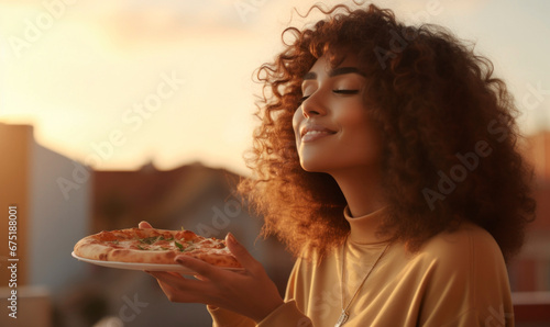 Woman eating pizza outdoors photo