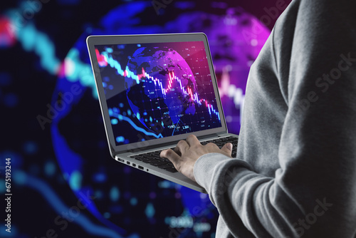 Fototapeta Naklejka Na Ścianę i Meble -  Close up of hacker hands using laptop falling forex chart on blurry grid background. Crisis, hacking, recession and financial loss concept.