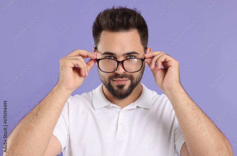Handsome man wearing glasses on violet background Handsome man wearing glasses on violet background