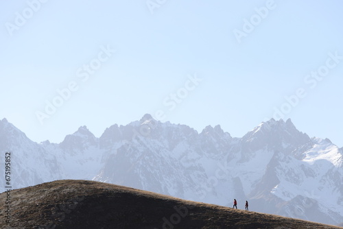 Group of mountaineers climbing a snowy mountain. Beautiful landscape background with silhouettes of climbers hiking on a peak.turkey