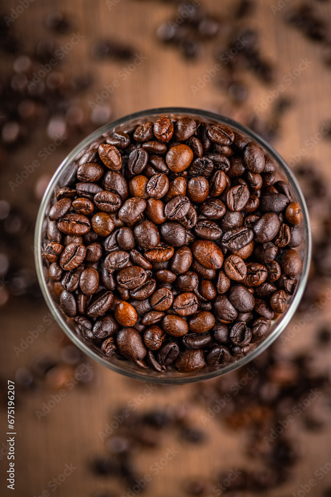 Fototapeta premium Roasted coffee beans in bowl. Top view.