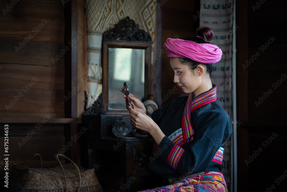 Pretty Asian Tai Lue women in beautiful traditional costumes doing