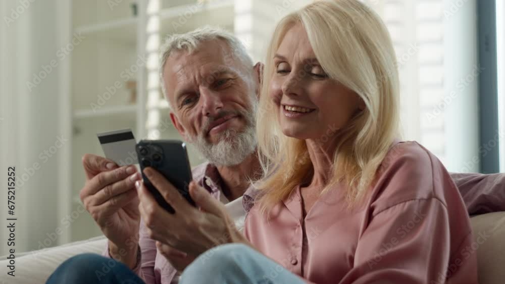 Elderly happy Caucasian married couple senior man woman retired make order purchase at online shop using phone pension credit card enjoy easy buying at ecommerce website use electronic bank services Elderly happy Caucasian married couple senior man woman retired make order purchase at online shop using phone pension credit card enjoy easy buying at ecommerce website use electronic bank services