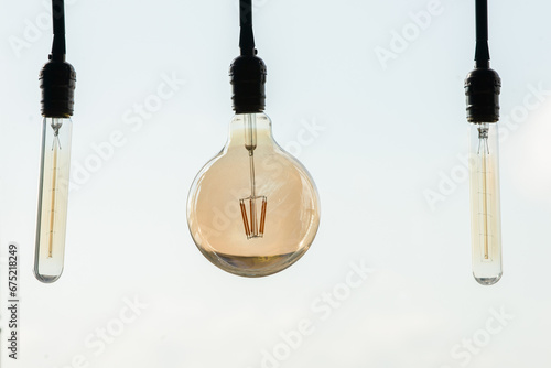 incandescent light bulb on the background of the sky