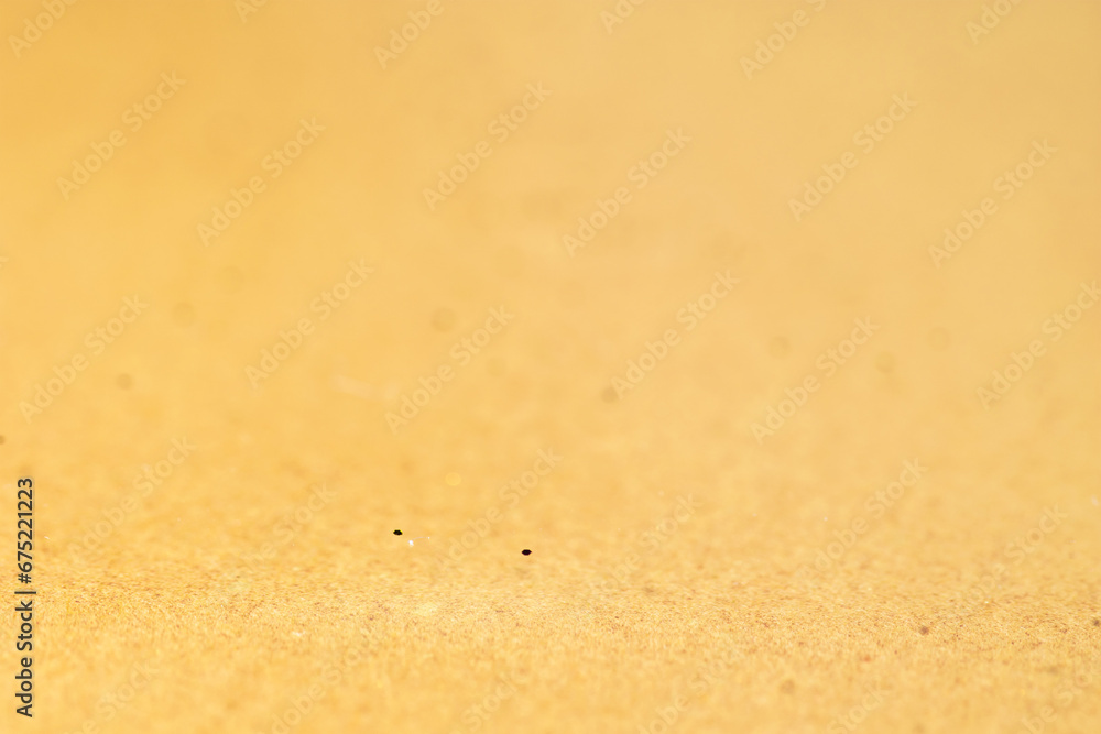 Golden or beige abstract glitter holiday background, paper texture. Golden or beige abstract glitter holiday background, paper texture.