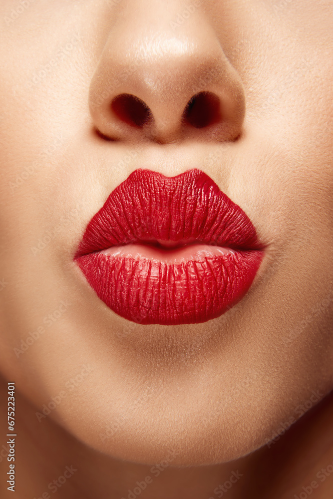 Blowing kiss. Cropped close up portrait of beautiful young girl with pout lips. Lip matte lipstick. Skin care routine. Blowing kiss. Cropped close up portrait of beautiful young girl with pout lips. Lip matte lipstick. Skin care routine.