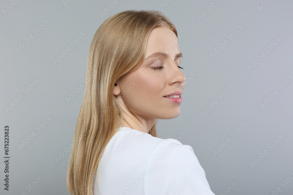 Portrait of beautiful young woman on grey background Portrait of beautiful young woman on grey background