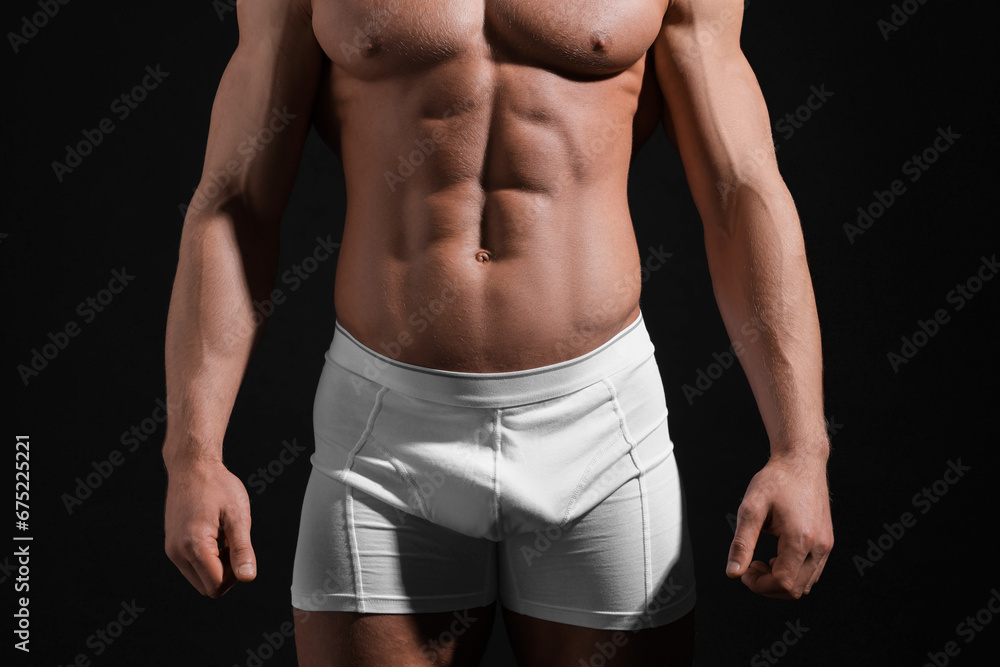 Young man in stylish white underwear on black background, closeup