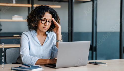 business woman with laptop stressed at work