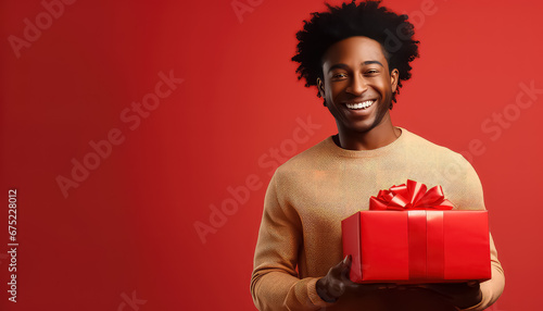 Black african man with red gift on background, valentine's day concept © yurakrasil