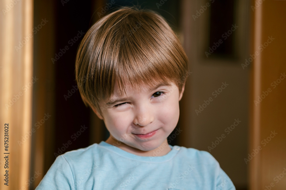 Portrait of smiling charming little toddler boy. He is giving a wink Portrait of smiling charming little toddler boy. He is giving a wink