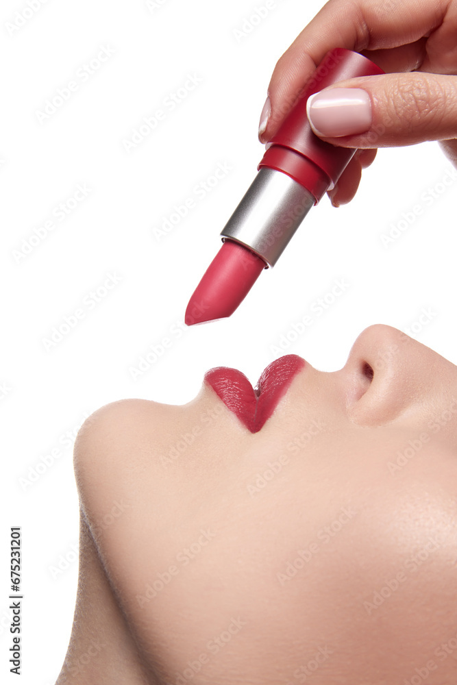 Close up view of model applying red lipstick. Professional fashion vivid make-up. Matte lipstick on full lips. Concept of style. Close up view of model applying red lipstick. Professional fashion vivid make-up. Matte lipstick on full lips. Concept of style.
