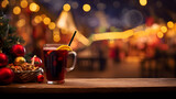 Glass of hot mulled wine on a table on a decorated Christmas street