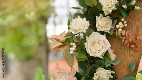 Backdrop of white roses with a soft focus and copy space. Element wedding arch with flowers on blurred background
