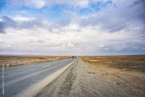 Automobile asphalt road highway through the desert in Karakalpakstan