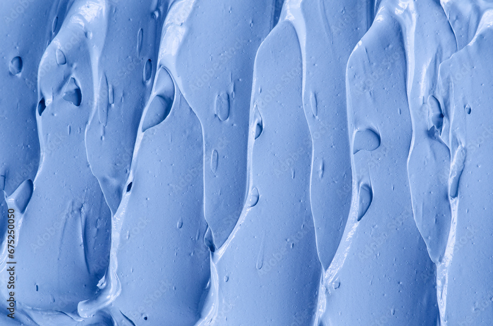Fototapeta premium Light blue bentonite facial clay (alginate mask, face cream, body wrap) texture close up, selective focus. Abstract background with brush strokes.