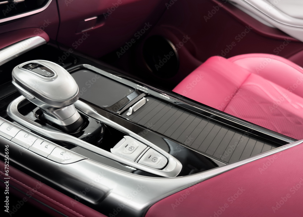Naklejka premium Automatic gear stick of a modern car. Modern car interior details. Close up view. Car inside. Automatic transmission lever shift. Brown leather interior with stitching