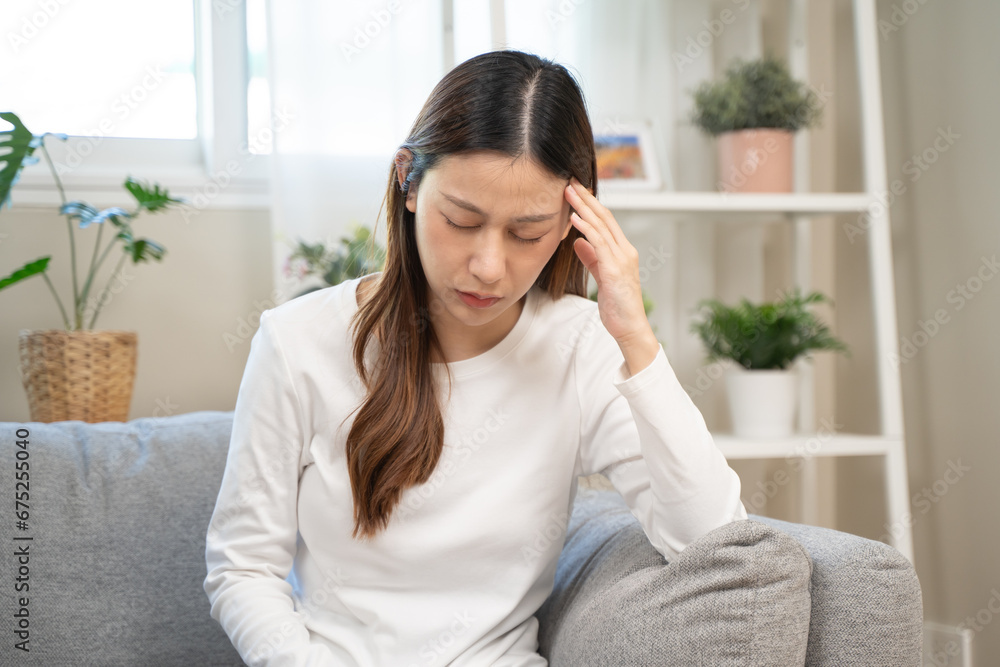 Brain stroke or low blood pressure symptom on people medical concept. Young beautiful woman has a dizziness and motion blurry during standing off sofa at home Brain stroke or low blood pressure symptom on people medical concept. Young beautiful woman has a dizziness and motion blurry during standing off sofa at home