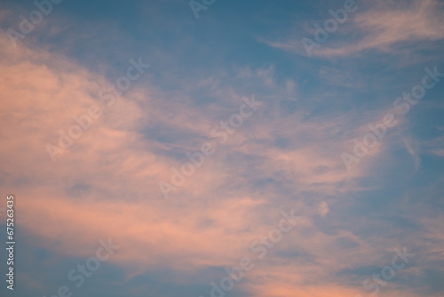 Light clouds in sky after sunset. Calm evening with clouds illuminated by last rays of sun