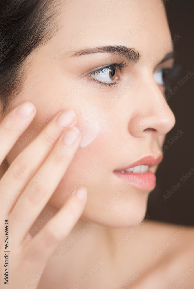 Close up of a woman applying moisturiser on her face
Close up of a woman applying moisturiser on her face