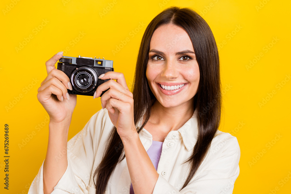 Photo of good mood positive woman with straight hairdo dressed white jacket hold vintage camera isolated on yellow color background Photo of good mood positive woman with straight hairdo dressed white jacket hold vintage camera isolated on yellow color background