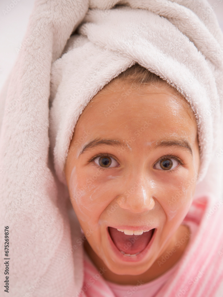 Close up of a girl with face mask on wearing a towel turban screaming and smiling
