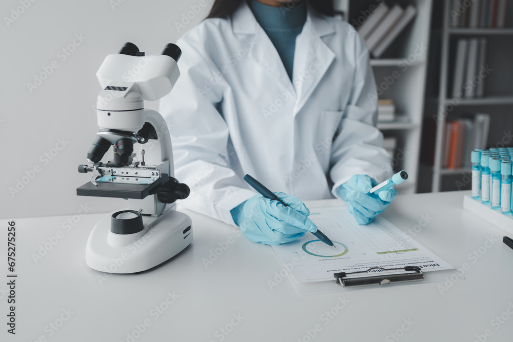 Chemist taking notes on research data, Scientist is working in the laboratory, Chemist is analyzing experimental results and taking notes in the laboratory, lab idea. Chemist taking notes on research data, Scientist is working in the laboratory, Chemist is analyzing experimental results and taking notes in the laboratory, lab idea.
