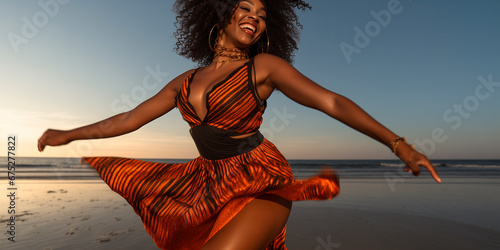 Fototapeta Naklejka Na Ścianę i Meble -  black woman joyfully dancing on beach barefoot in sexy outfit