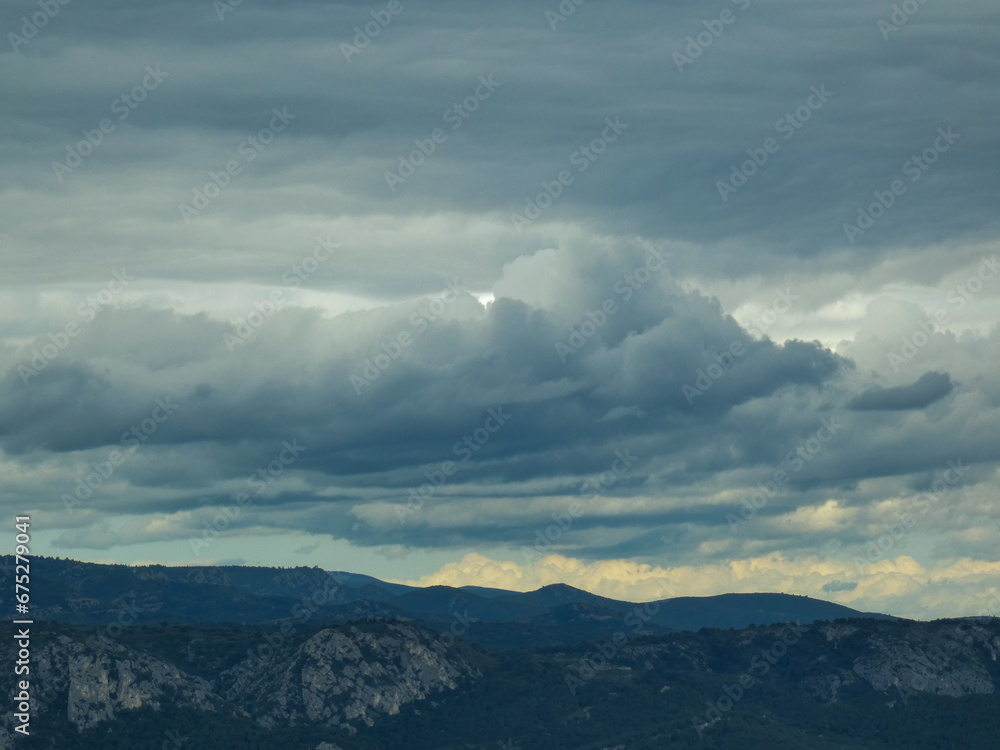 Stormy skies with threatening gray clouds hanging over the Luberon mountains in Provence in France 