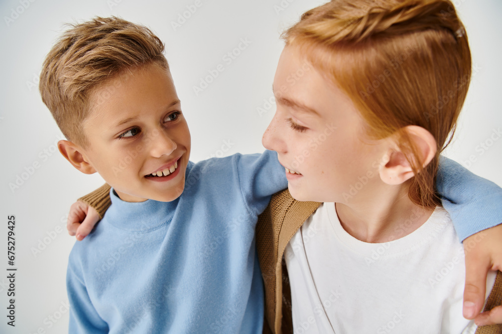 cute preteen children in trendy casual attires hugging and smiling at each other, fashion concept cute preteen children in trendy casual attires hugging and smiling at each other, fashion concept