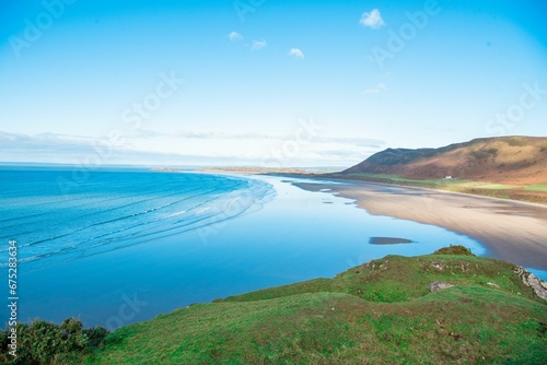 Idyllic scene of Rhossili Bay at the southwestern tip of the Gower Peninsula in the United Kingdom.