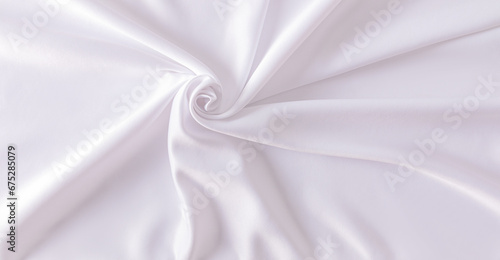 A chic wedding or festive textile background made of white satin fabric. Spiral of fabric. abstract background. Design layout.