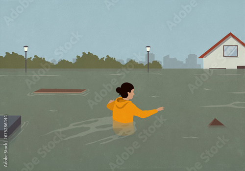 Woman wading through debris in flooded street
 photo