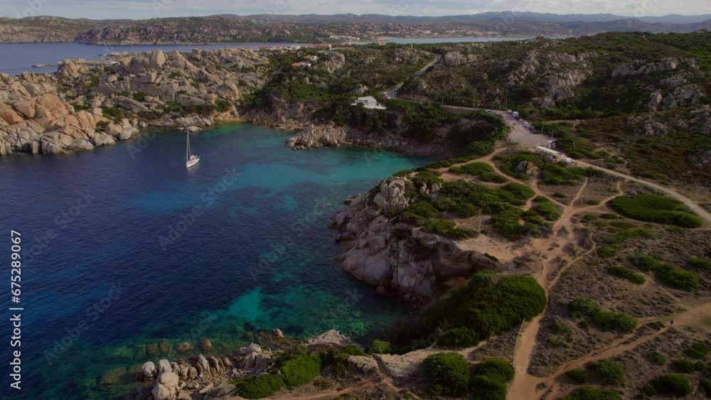 Wonderful aerial view in orbit over one of the coves located in Cape Testa on the island of Sardinia, with beautiful colors of the sea. Wonderful aerial view in orbit over one of the coves located in Cape Testa on the island of Sardinia, with beautiful colors of the sea.