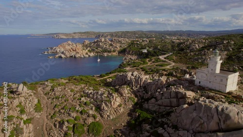 Aerial view discovering the Cape Testa lighthouse on the island of Sardinia and seeing the beautiful coast and its small beaches. photo