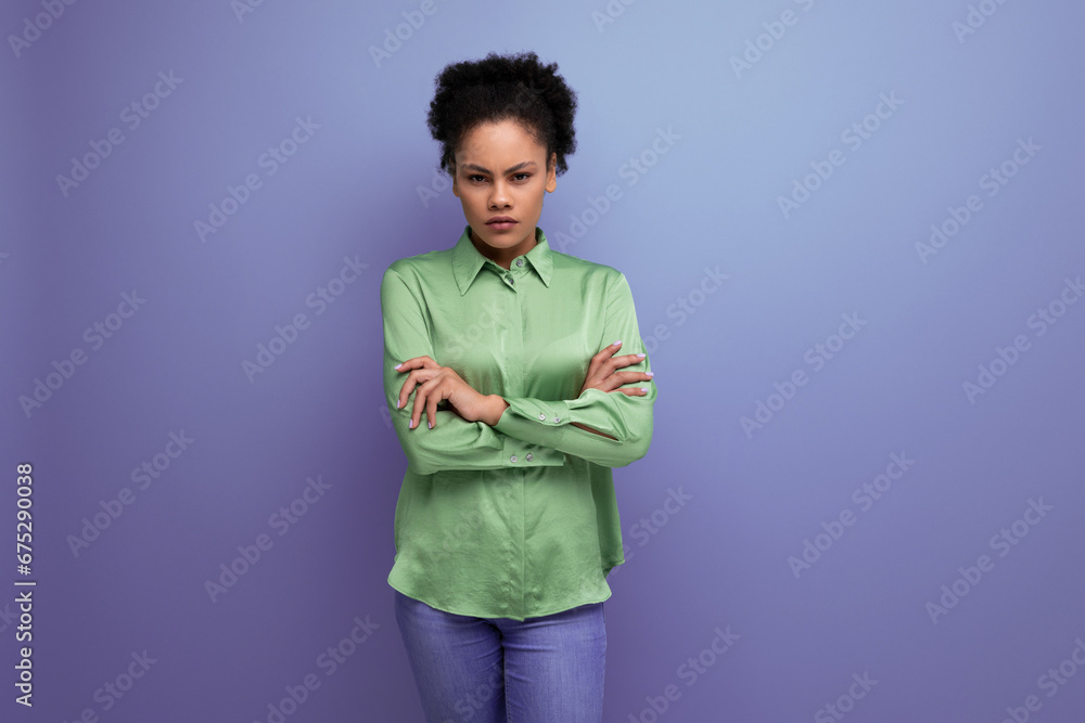 young hispanic brunette lady dressed in a green stylish shirt against the background with copy space young hispanic brunette lady dressed in a green stylish shirt against the background with copy space