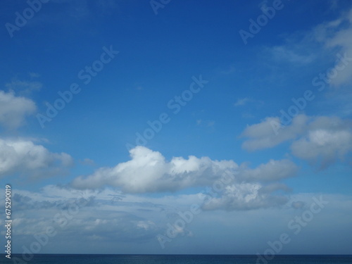 The blue sky and white clouds are natural beauty. The sky with white clouds scattered during the summer day. 