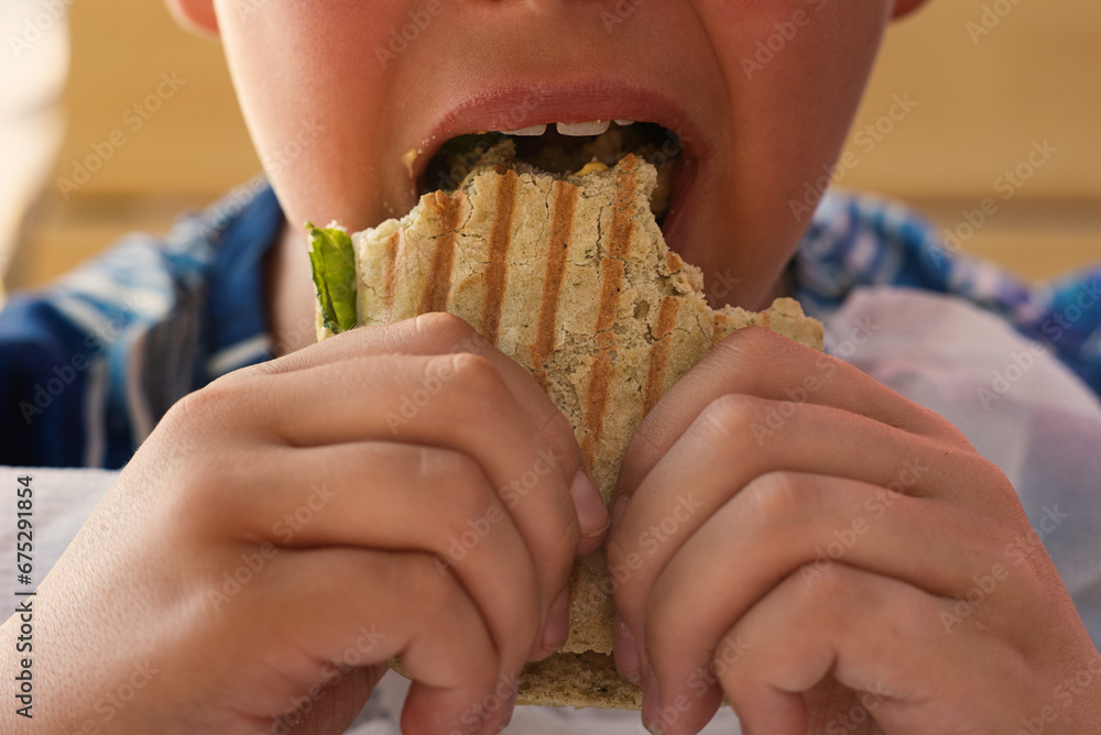 Teenage boy eating snacks close-up. Snack, sweets, street food. Intermediate meal. Mouth with teeth, tongue and saliva Teenage boy eating snacks close-up. Snack, sweets, street food. Intermediate meal. Mouth with teeth, tongue and saliva