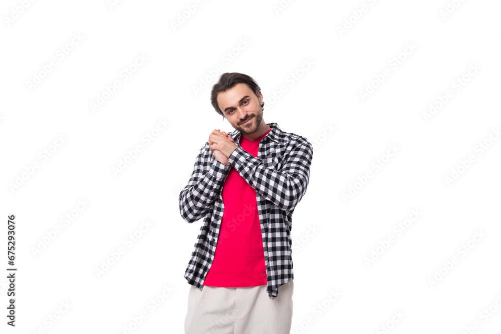 handsome pleasant young european man with black hair and beard in a shirt on a white background with copy space handsome pleasant young european man with black hair and beard in a shirt on a white background with copy space