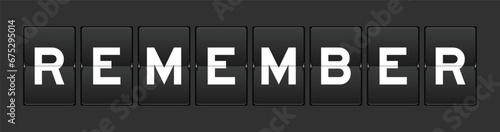 Black color analog flip board with word remember on gray background